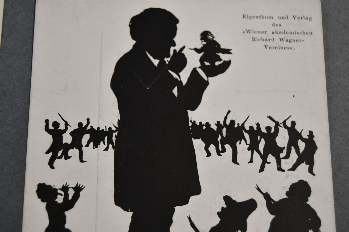 3 Bildpostkarten. Silhouetten von Richard Wagner (2) und Sohn Siegfried (1). U.a. Richard Wagner als Dirigent (Wien, 1. März 1875) und umgeben von zwerghaften Kritikern, von denen er einen (wohl Eduard Hanslick) auf der Hand trägt. Beiliegt eine Silhouette von Richard Wagner als Dirigent (Musikverein WIen, 14.3.1875) aus dem "Merker", Heft 9, 1910.